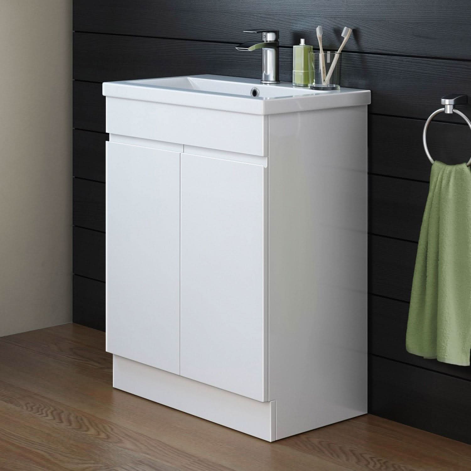 The iBathUK Trent Close Coupled Toilet & Vanity Unit with Basin is a gloss white, space-saving bathroom combo featuring the WC pan and vanity from iBathUK. It stands out against a dark wood wall, complemented by a green hand towel and toothbrushes on the sink.