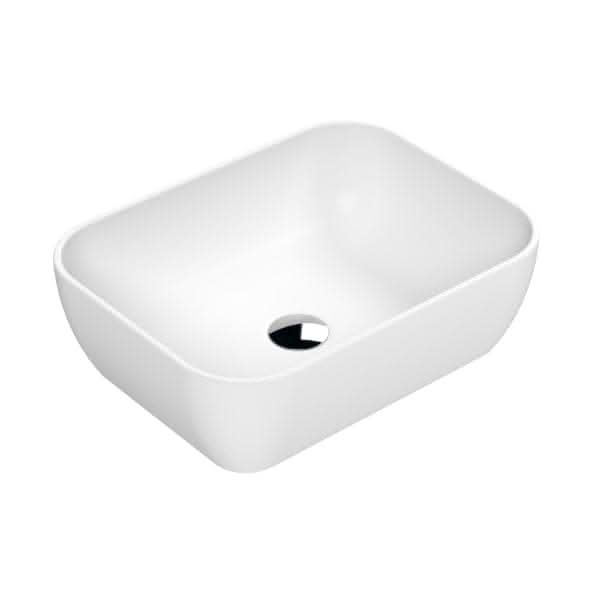 The Nuie 455mm Sit-On Countertop Basin - No TH by Nuie is a modern rectangular matt white basin with rounded corners and a central drain, featured from an angled top view. Made from premium vitreous china for lasting durability and style.