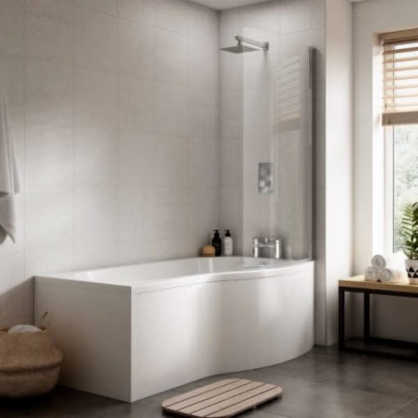 A modern bathroom with a Nuie Square P Shape Shower Bath in white, glass shower screen, light tiles, wicker basket, wooden bench, rolled towels, and a bath mat for a fresh and stylish look.