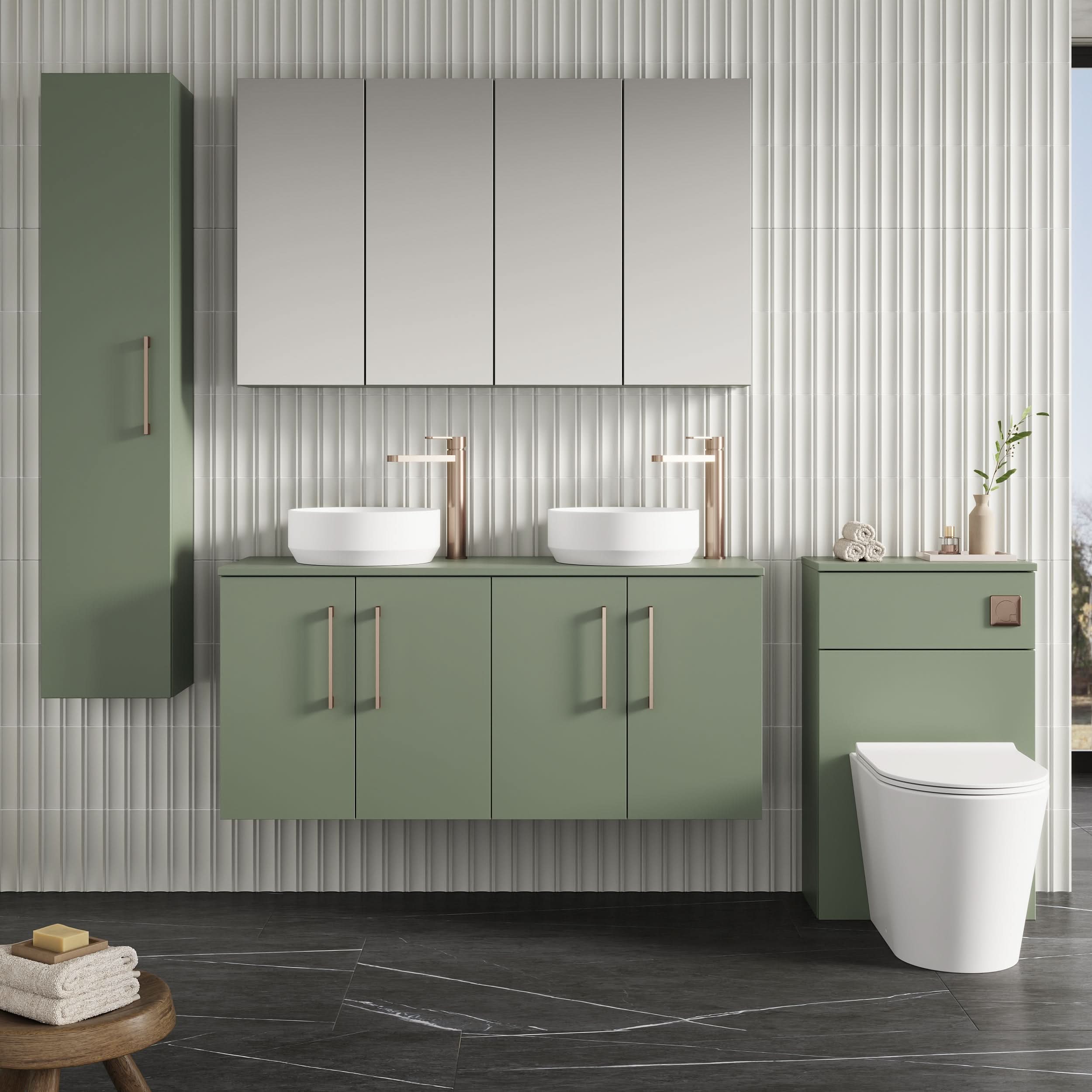 Modern bathroom featuring a Nuie Arno 4 Door 1200mm wide wall hung vanity unit with worktop in sage green, twin vessel sinks with rose gold faucets, mirrored cabinets above, vertical cabinet left, and white toilet right against light textured tiles.