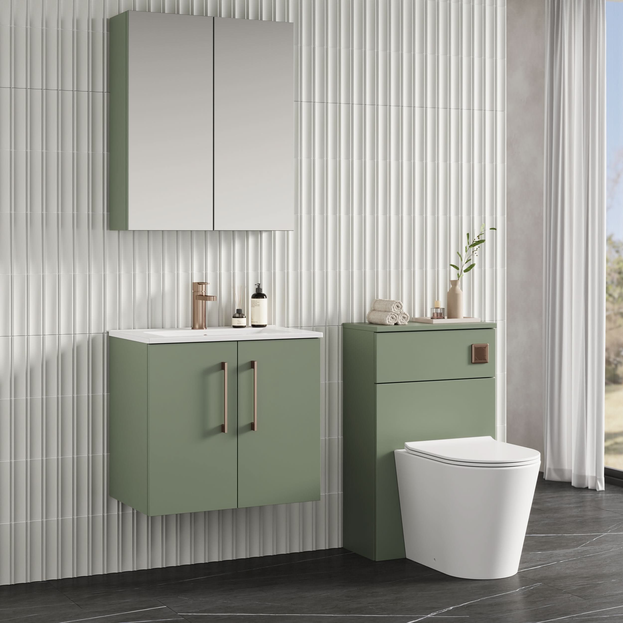 Modern bathroom featuring sage green cabinets, a wall-mounted mirrored cabinet, Nuie Arno 2 Door Wall Hung Vanity Unit With Basin-2 (600mm), bronze faucet, white toilet, vertical white tiles, and ample natural light from a window.