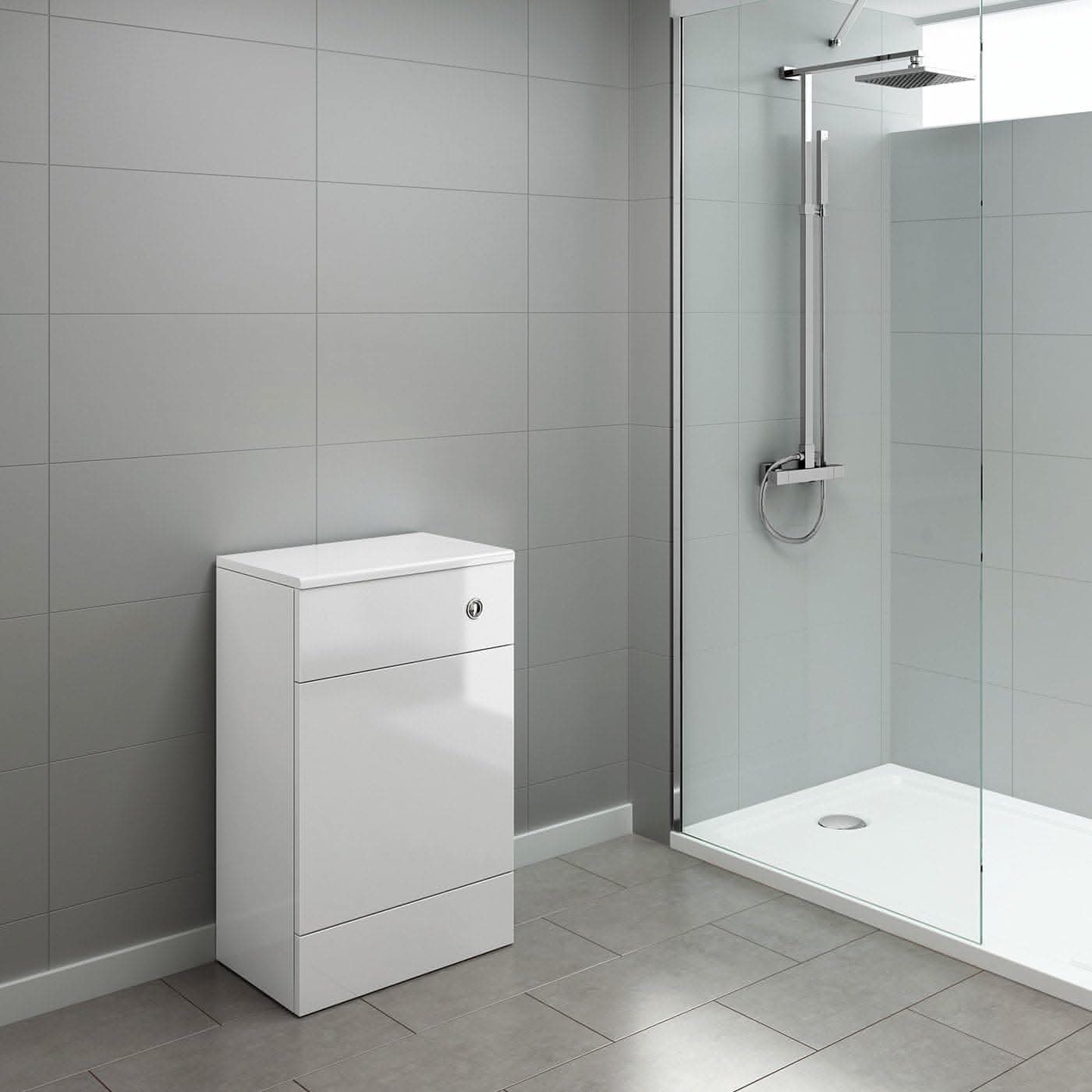 Modern bathroom with light gray tiles, a glass walk-in shower featuring a rainfall showerhead, and an iBathUK Harper Back To Wall WC Unit paired with a white storage cabinet for the perfect upgrade.